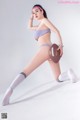 A woman in a bikini holding a football.