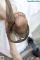 A close up of a woman's feet with a pair of black shoes.