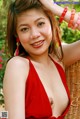 A woman in a red dress posing for the camera.