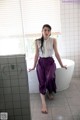 A woman sitting in a bathtub in a bathroom.