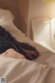 A person laying on a bed with their head on a pillow.